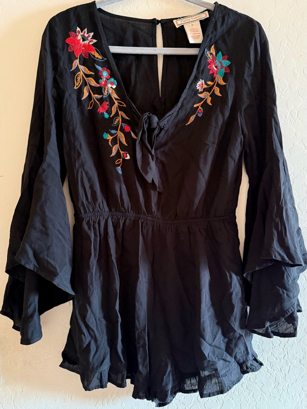 Flying Tomato, medium black romper with floral embroidery around the neckline